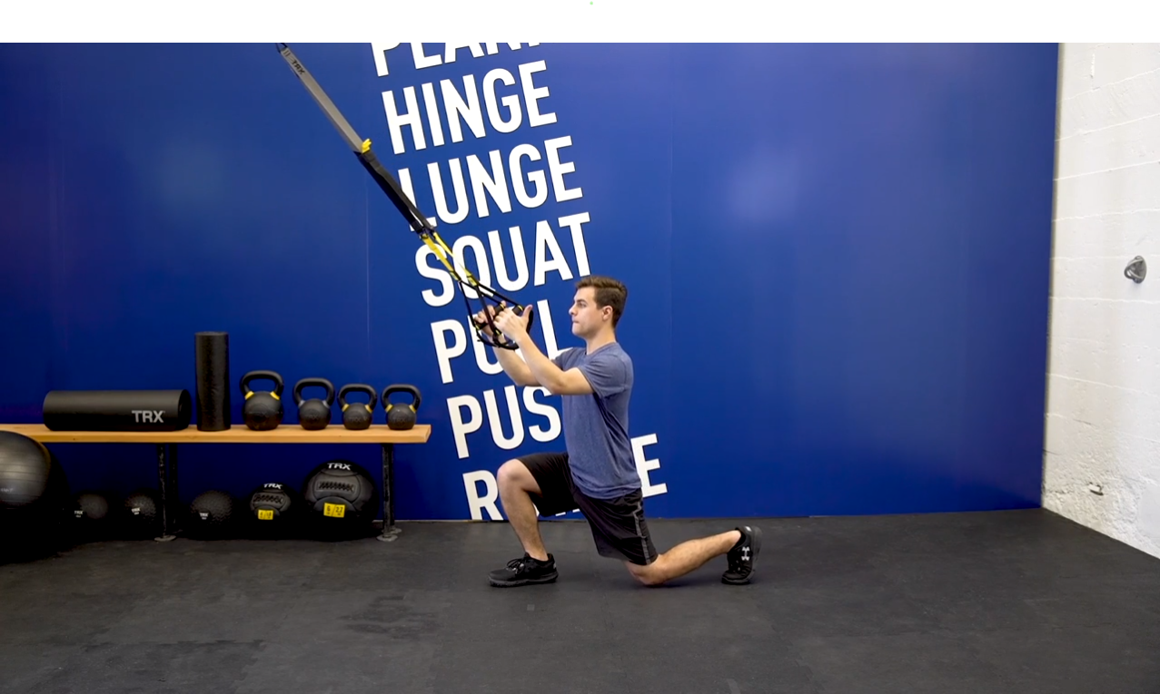 Image description: A young man demonstrating a TRX Step Back Lunge